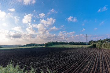 Fototapeta na wymiar plowed field and blue sky in Japan