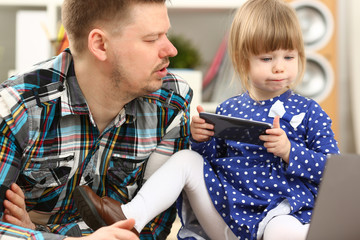 Cute little girl on floor carpet with dad