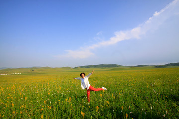 A female visitors leisure in the WuLanBuTong grassland, China