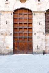 European wooden door in a white brick wall