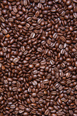 Vertical background of roasted Colombian coffee beans