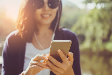 Woman hand using smartphone.