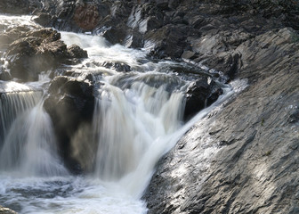 close up on flowing water cascade in the river