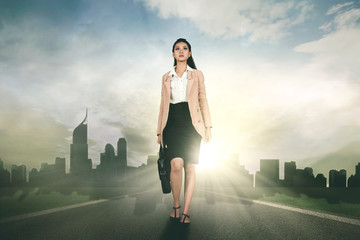Fototapeta na wymiar Caucasian businesswoman walks on the road