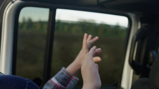 Happy Little Boy Raises His Hands In Air In Car Seat, In Jeep With Top Off, Slow Motion