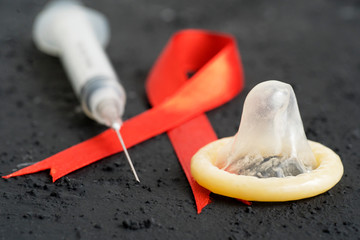 Injection and red ribbon with condom