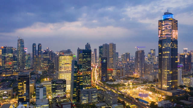 Fototapeta Jakarta city with glowing office building