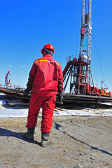 Fototapeta premium Oil field oil workers at work