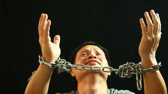 Man dragging  chain with black  background
