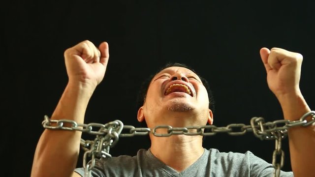 Man dragging  chain with black  background
