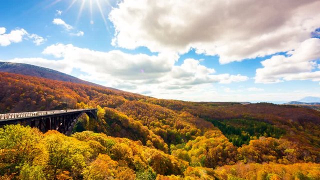 Time lapse video Jogakura Bridge in aomori city with Autumn Leaves background and movement cloud A wonderful view of Jyogakura-keiryu Stream a famous place in the Towada-hachimantai National Park.