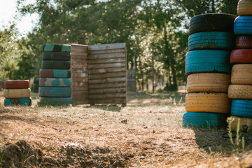 Lasertag playground with barricades made of car tires and wooden planks