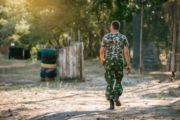 Back view of male lasertag instructor on shooting range