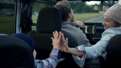Happy Mom Gives Her Little Boy A High Five On Family Car Ride Through Beautiful Countryside, Slow Motion