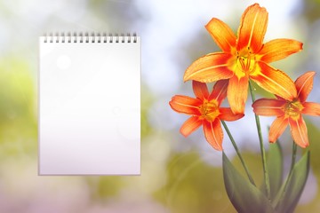 Beautiful live lily with notebook with blank place for your content on left on nature leaves and branches bokeh background. Floral spring or summer flowers concept.