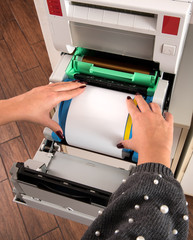 Woman loading a roll of photographic film paper