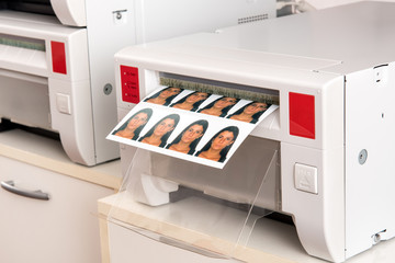 Printing passport photos of a woman on a printer
