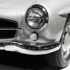 Vintage car headlight close up. Old luxury car classic design. Black and white colors