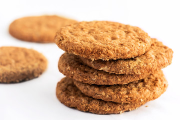 Homemade shortbread cookies made of oatmeal are stacked on a white table background. Food snack concept and with copy space for text.