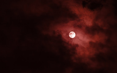 Full moon with red clouds in the night sky © axivan.com