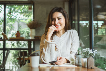 Asian woman working on labtop in coffee shop