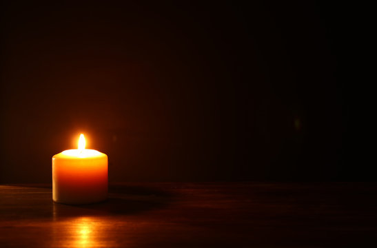 Burning candles over black background.