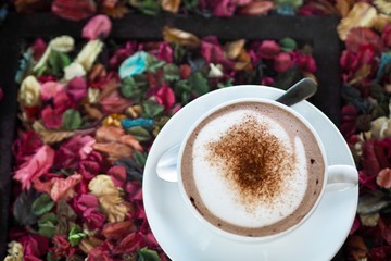 Sweet hot coco cup on vintage dried flora table in early morning to increase your energy 