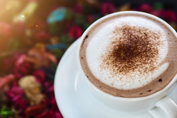 Sweet hot coco cup on vintage dried flora table in early morning to increase your energy 