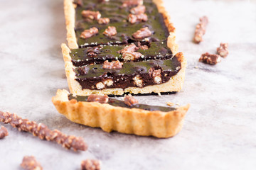Chocolate tart with cookies on gray table background