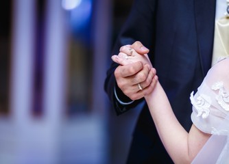 Obraz na płótnie Canvas groom and bride holding hands
