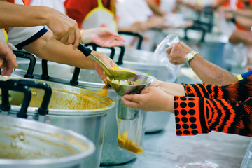 Volunteers Share Food to the Poor to Relieve Hunger: Charity concept