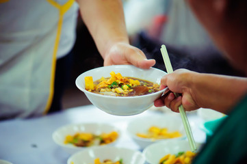 Volunteers Share Food to the Poor to Relieve Hunger: Charity concept