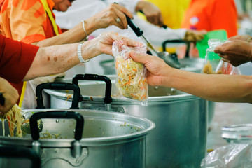 Volunteers Share Food to the Poor to Relieve Hunger: Charity concept