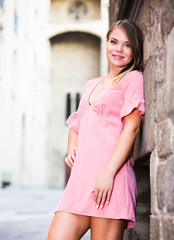 City portrait of woman near old wall