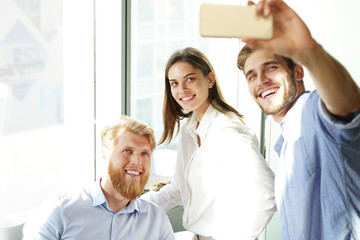 Group shot of colleagues having fun in their office.