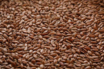 Background texture of seeds of dark brown flax.