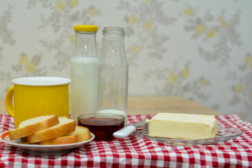 Nutritious breakfast - milk, butter, toast and jam. Delicious homemade food.