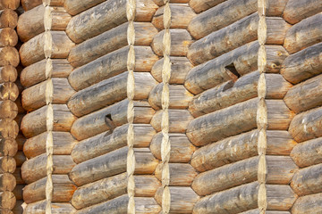 Wall with log house in the house as a background