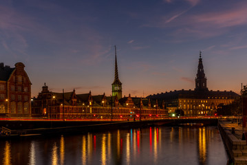 Obraz premium View of the Borsen (Danish for exchange) building in Copenhangen at night reflecting in the water channel - 1