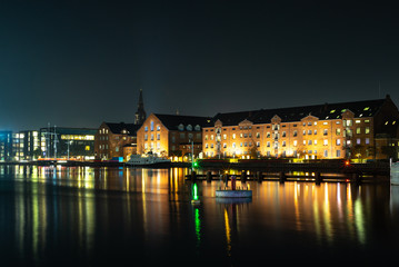 Fototapeta na wymiar Waterside buildings in Copenhangen during a colorful sunset reflecting in the water channel - 2