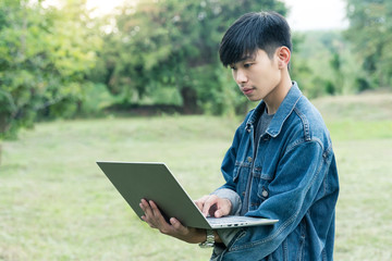 A young man seriously looking at his laptop