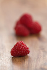 Ripe raspberries on wood background