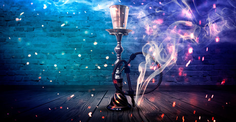 Hookah on the background with smoke, neon light, rays, sparks