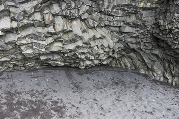 Closeup natural basalt stone columns near the city Vik in Iceland. Texture and background