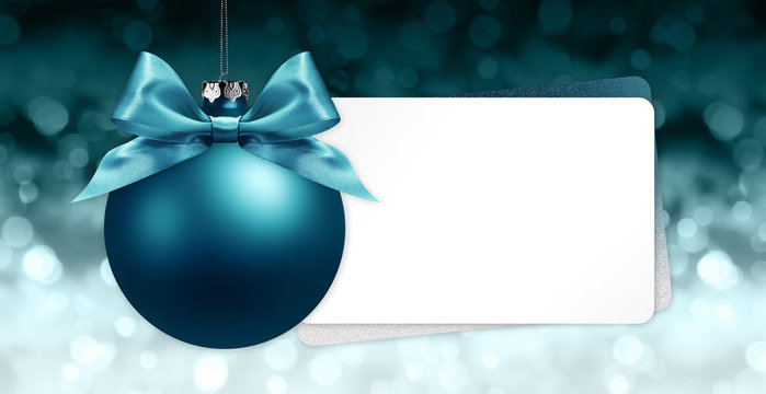 merry christmas signboard or gift card, blue ball with blue ribbon bow on blurred red xmas lights, copy space blank background