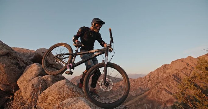 Mountain biker stepping up the mountains with a bike, ready for ride down - getting away from it all, activity, extreme 4k