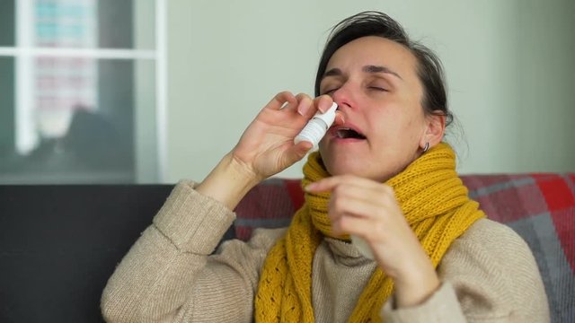 Sick Young Woman Using Nasal Spray