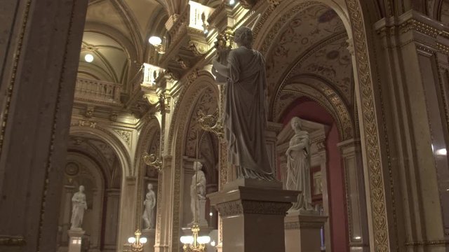 Vienna State Opera from the inside. Columns, statues and arches in the interior. Dolly shot .