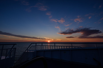 Fototapeta na wymiar colorful dramatic sunrise in the sea. view from ferry