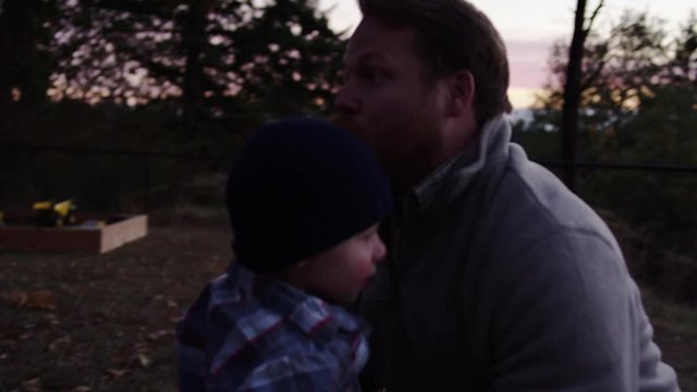Little Boy Runs Into His Father's Arms, Father Picks Up And Throws Him High In The Air, Slow Motion
